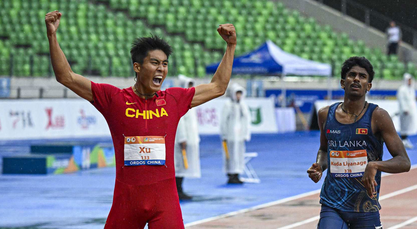 Xinfeng Yu of China celebrates his NR equalling run in 400H final.